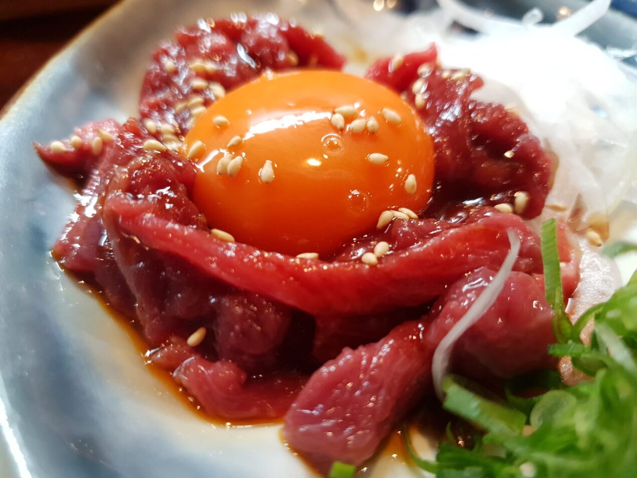 horse meat tartare with raw egg yolk on top