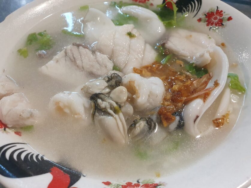 close up of seafood congee at Khao Tom Pla Plaeng Nam 