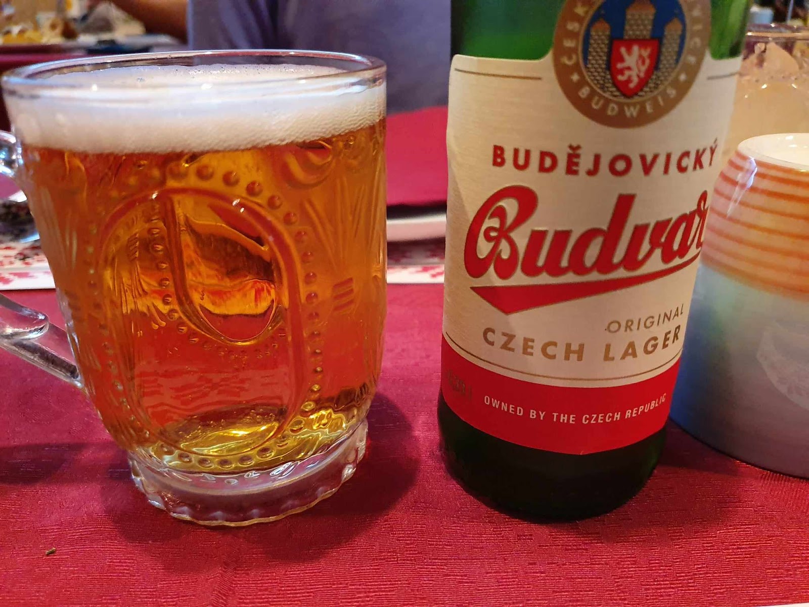 Budva bottles with beer poured in glass