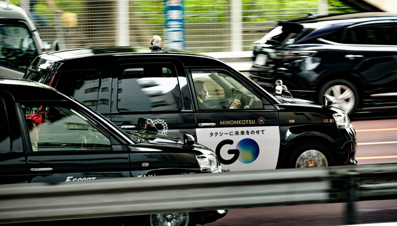 black Japanese taxi with Go sign