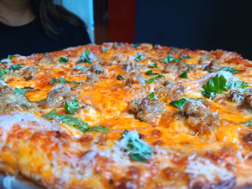 close-up of New Haven-style Homemade Sausage pizza at Fini's Italian American 